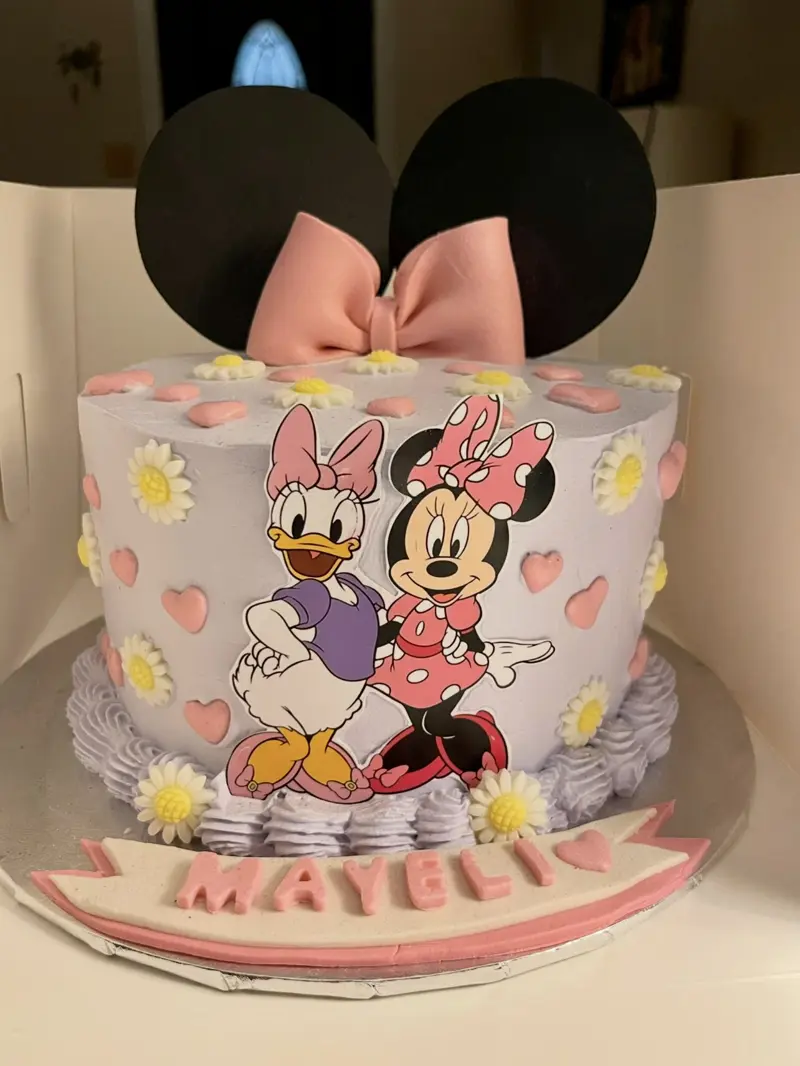 Minnie Mouse and Daisy Duck birthday cake with daisies and hearts