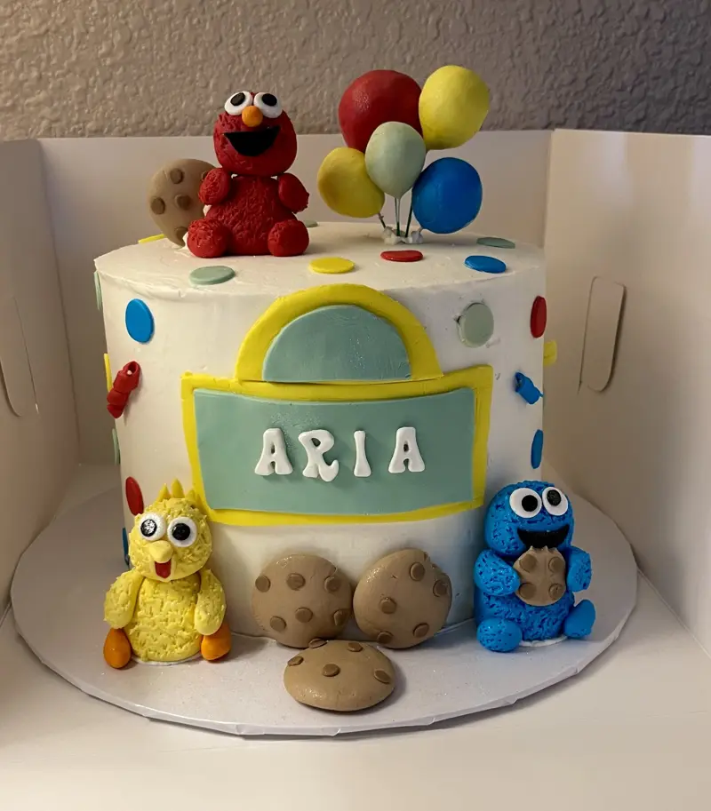 Sesame Street birthday cake with Elmo, Big Bird, Cookie Monster and balloons